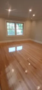 Completed Greenwich kitchen with polished flooring, new sheetrock, and fresh paint.