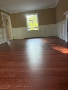 Refinished hardwood floors showcasing a smooth, glossy finish.