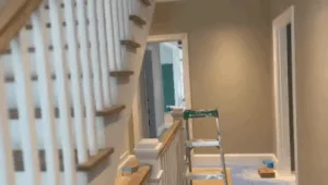 Interior painting project showing staircase with painted balusters.