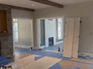 Interior painting project with fireplace, doors, and trim preparation.