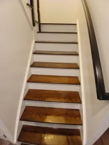 Refinished wooden staircase with a polished surface.
