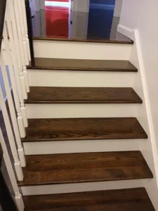Refinished wooden staircase with a polished finish, showing details.