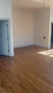 Finished room after hardwood floor refinishing with natural light.