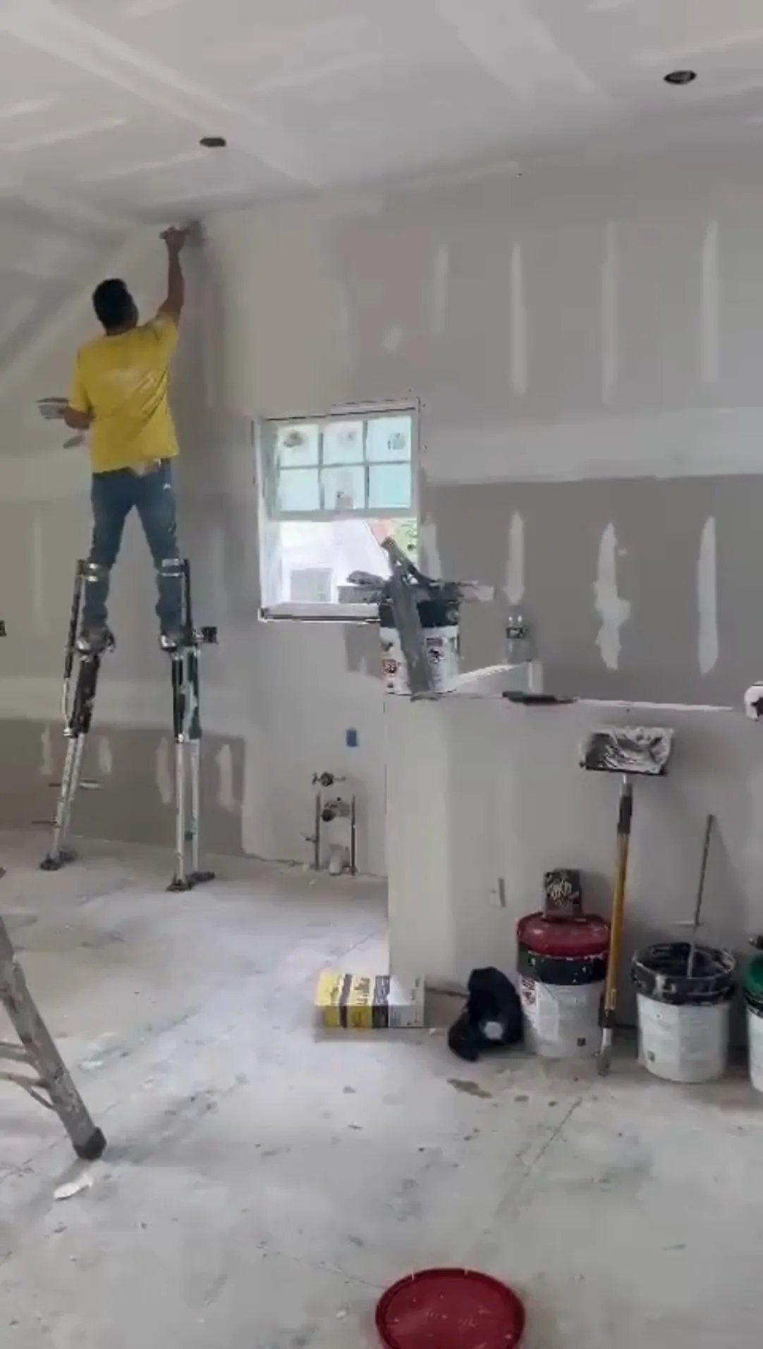 Drywall repair in progress before hardwood floor refinishing.
