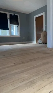 Sanded surface prepared for floor refinish old house process.