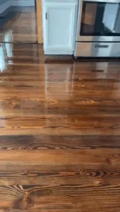 Completed floor refinish old house with glossy stained wood.