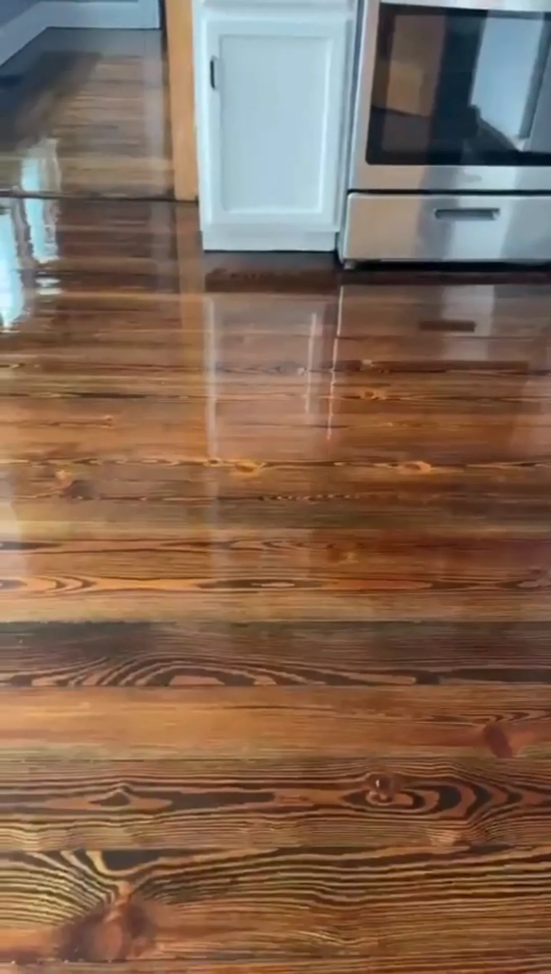 Completed floor refinish old house with glossy stained wood.