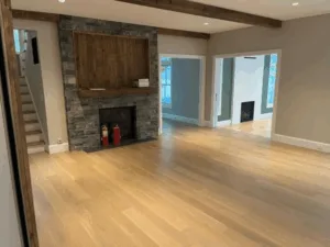 Living room with stone fireplace and wooden beams – Flooring and Painting in Newtown