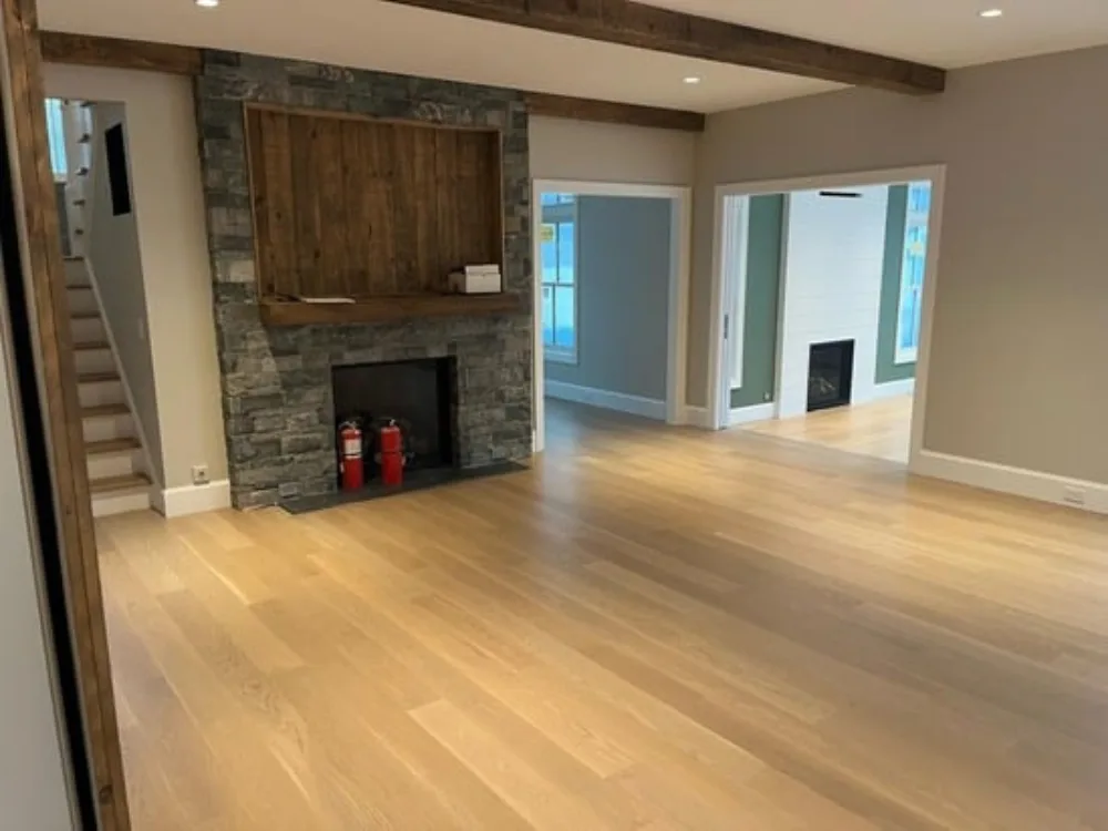 Living room with stone fireplace and wooden beams – Flooring and Painting in Newtown