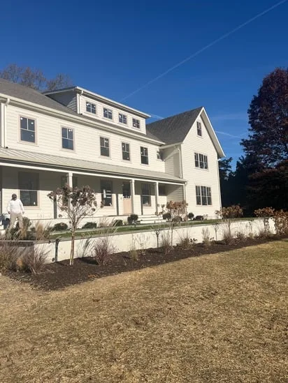 Exterior house painting project highlighting side elevation with consistent paint coverage and refined exterior surfaces.