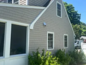 Exterior house painting featuring side elevation with updated siding and trim finish