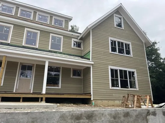 Front facade showing the progress of an exterior painting Fairfield CT project on a multi-story residence.