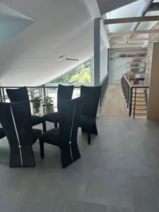 Modern dining area highlighting premium tile and interior painting on vaulted ceilings.